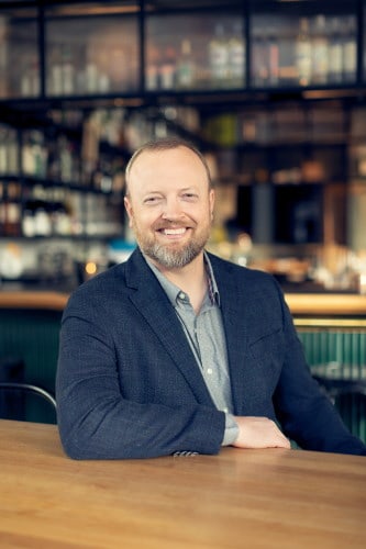 Ross Dunn sitting at a table with a sports jacket